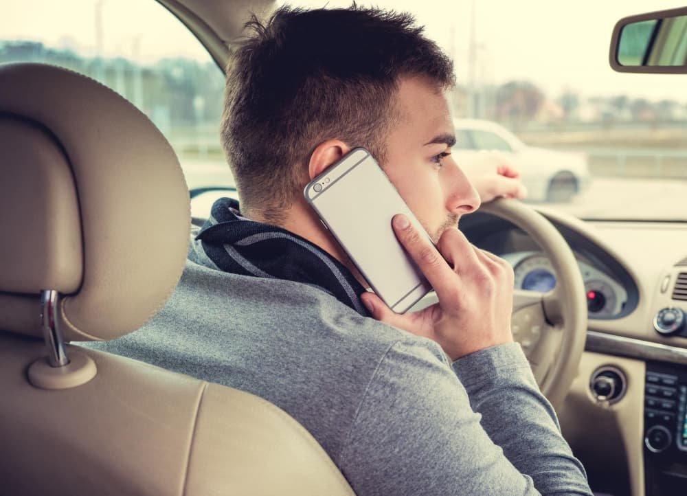 Man Using a Mobile Phone While Driving